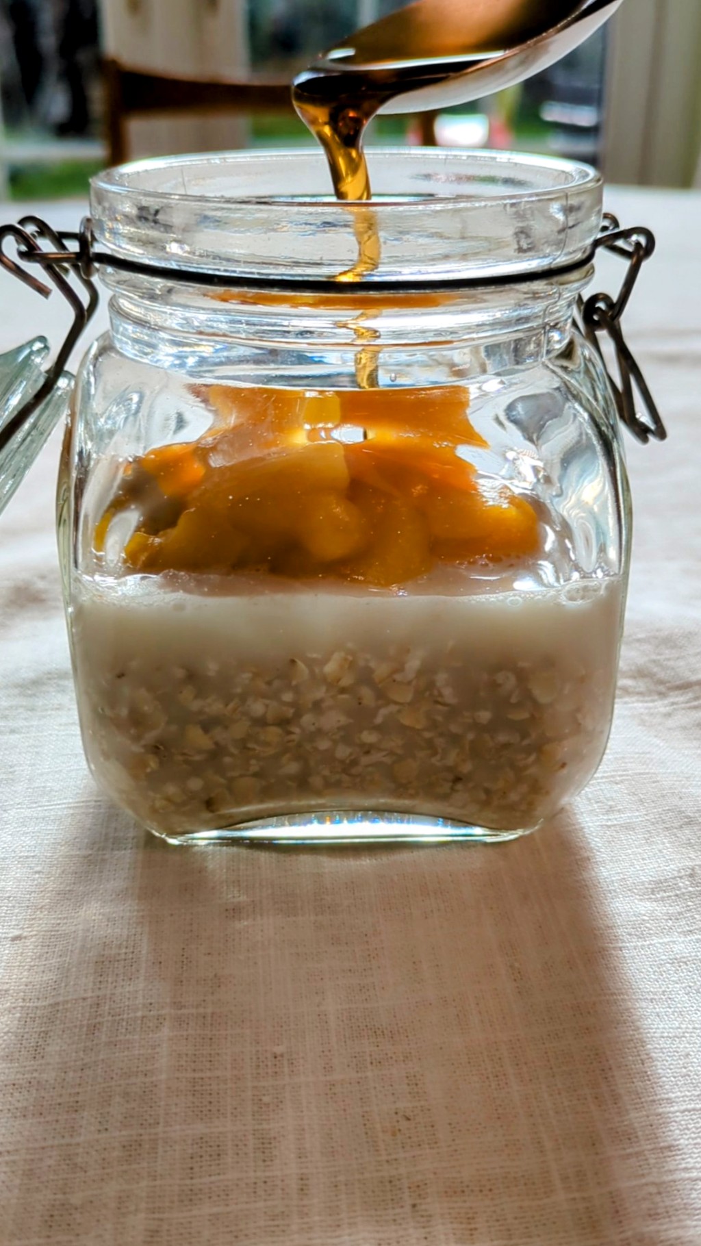 Pumpkin pie overnight oats layered in a glass jar.